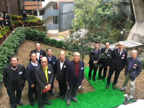 Distinguished alumni and guests witnessing the planting of the oak tree.